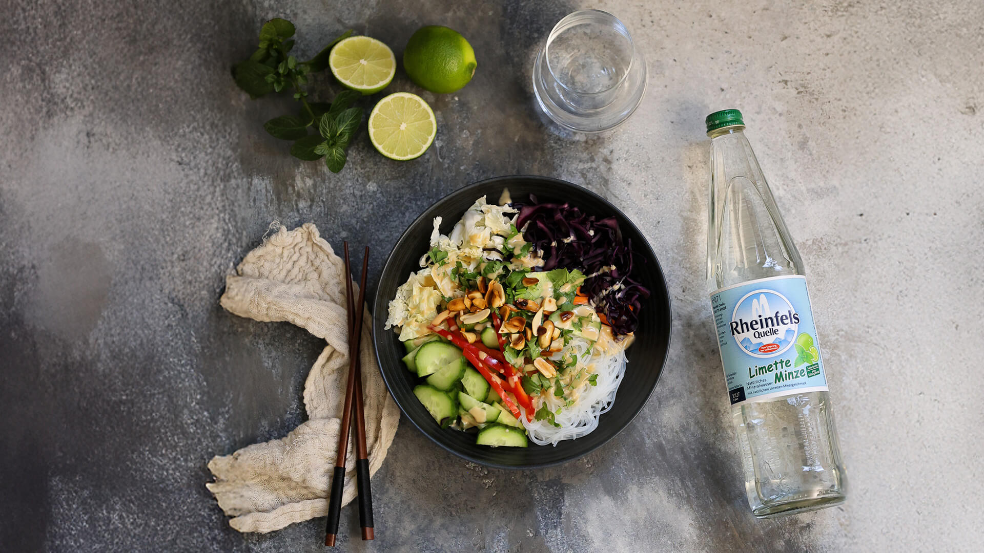 Asiatischer Salat mit einer Rheinfels Quelle Limette-Minze Flasche